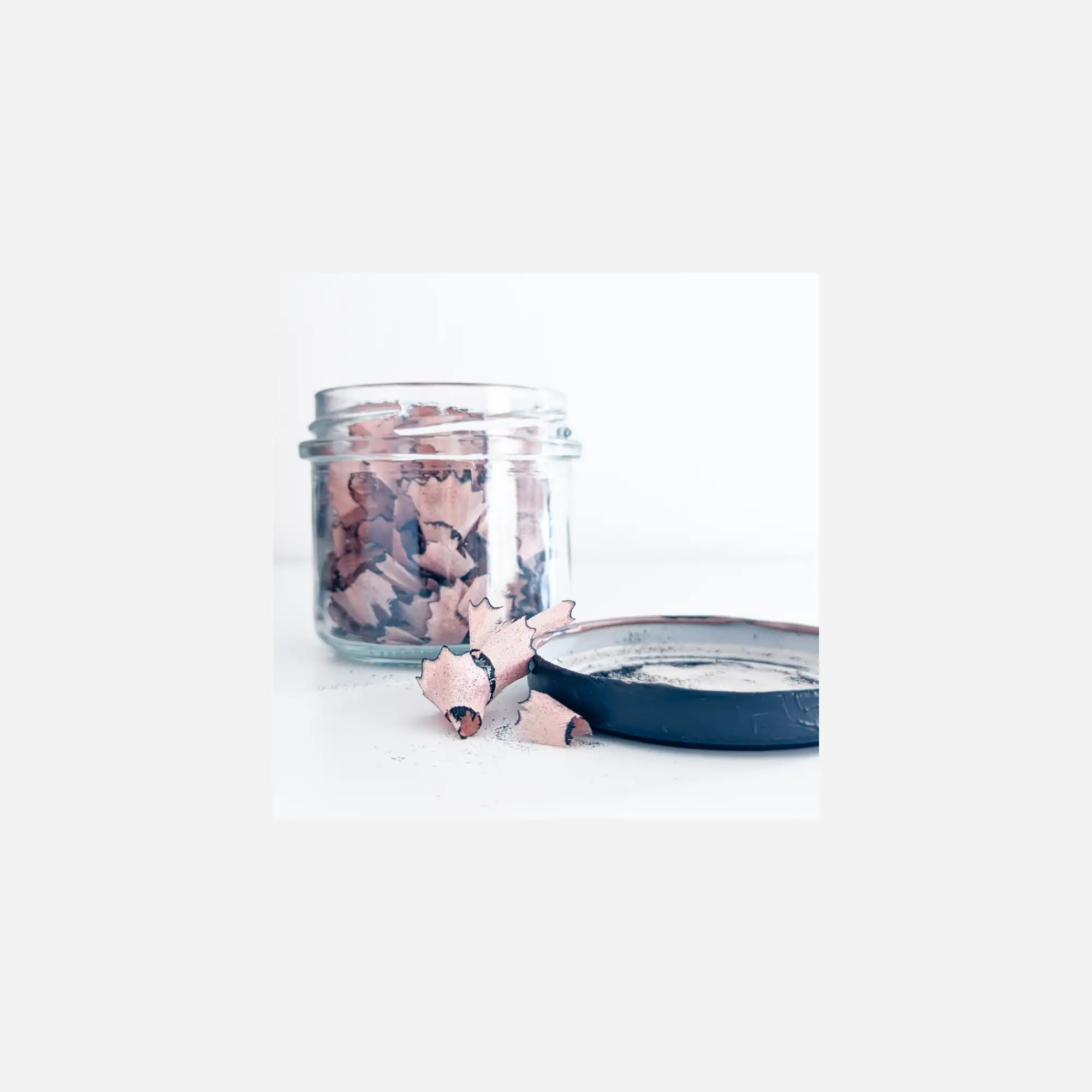 open jar with the remains of the sharpened pencil inside
